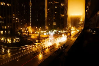 Night cityscape with long exposure light trails on wet street