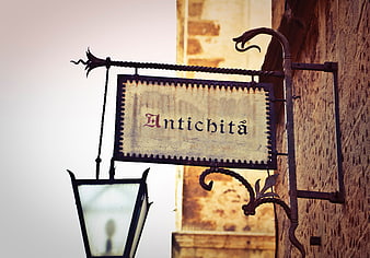 Vintage Antichita Shop Sign with Lantern on Wall