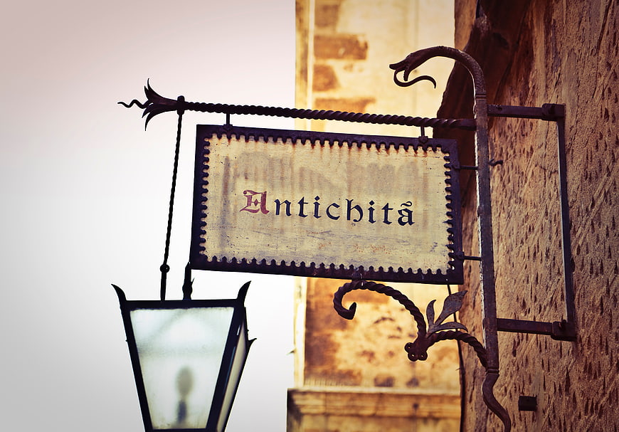 Vintage Antichita Shop Sign with Lantern on Wall