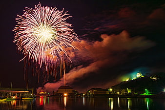 Spectacular Fireworks Display Over Japanese Harbor at Night