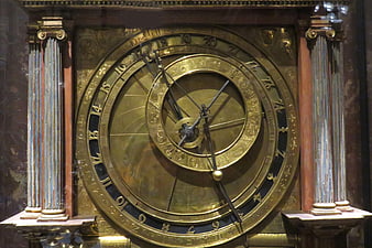 Antique brass astronomical clock with intricate dials and columns