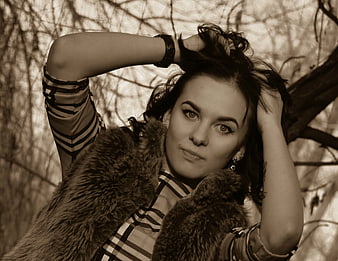 Sepia Portrait of Woman in Fur Vest in Woods