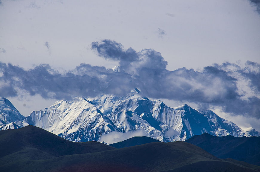 Snow-Capped Gongga Mountain Peaks With Dramatic Clouds