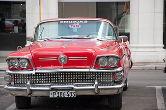 Front view of classic red 1957 Buick taxi in Cuba