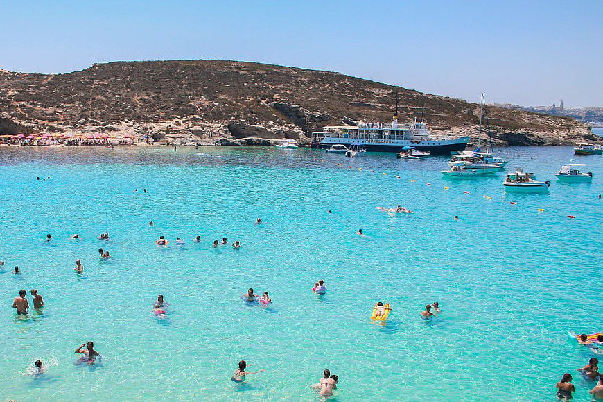 Crowded Beach with Turquoise Water and Tour Boats