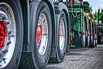 Close-up of heavy-duty truck wheels with red hubs