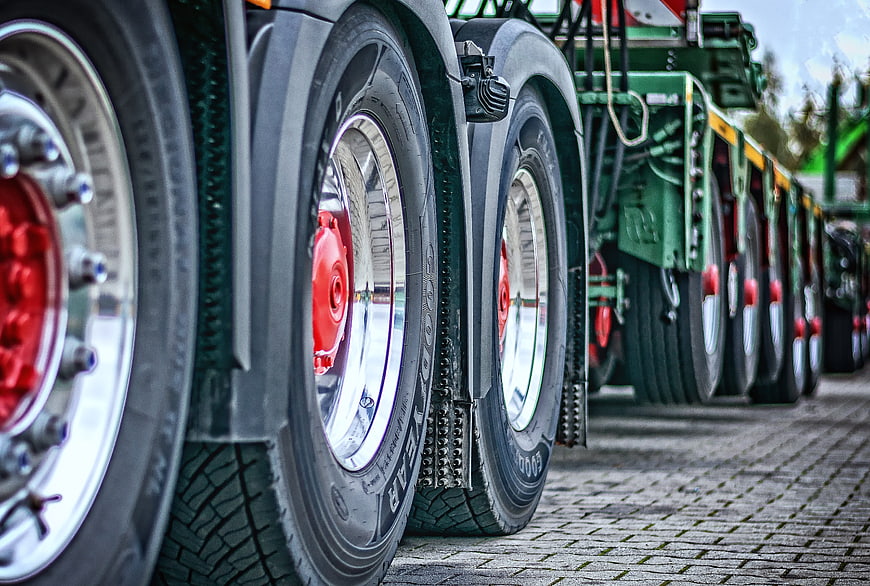 Close-up of heavy-duty truck wheels with red hubs