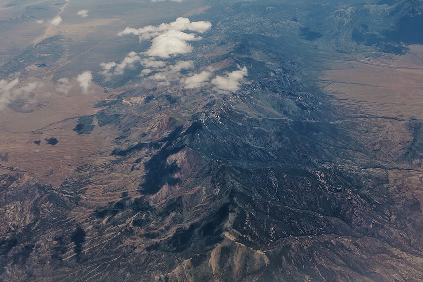 Aerial View of Rugged Mountain Range with Cloud Shadows