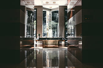Modern hotel lobby with polished marble floor and reception desk