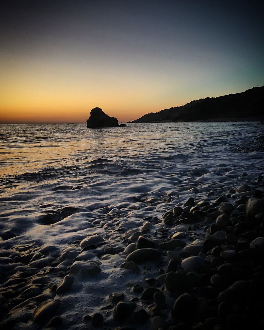 Sunset Seascape with Rocky Shore and Ocean Rock