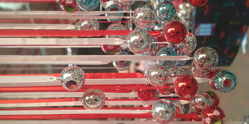 Red, Silver, and Teal Christmas Ornaments Hanging on Ribbons