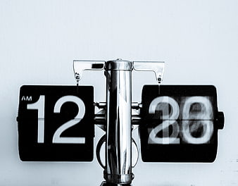 Close-up of vintage flip clock showing 12:20 AM
