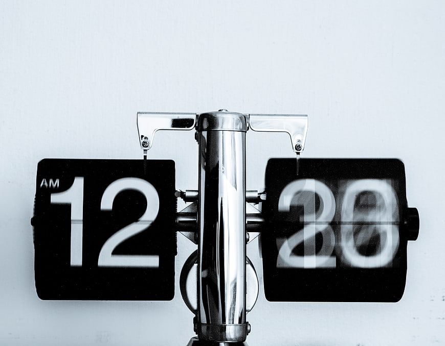 Close-up of vintage flip clock showing 12:20 AM