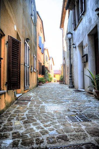 Narrow cobblestone street in Tavullia, Italy