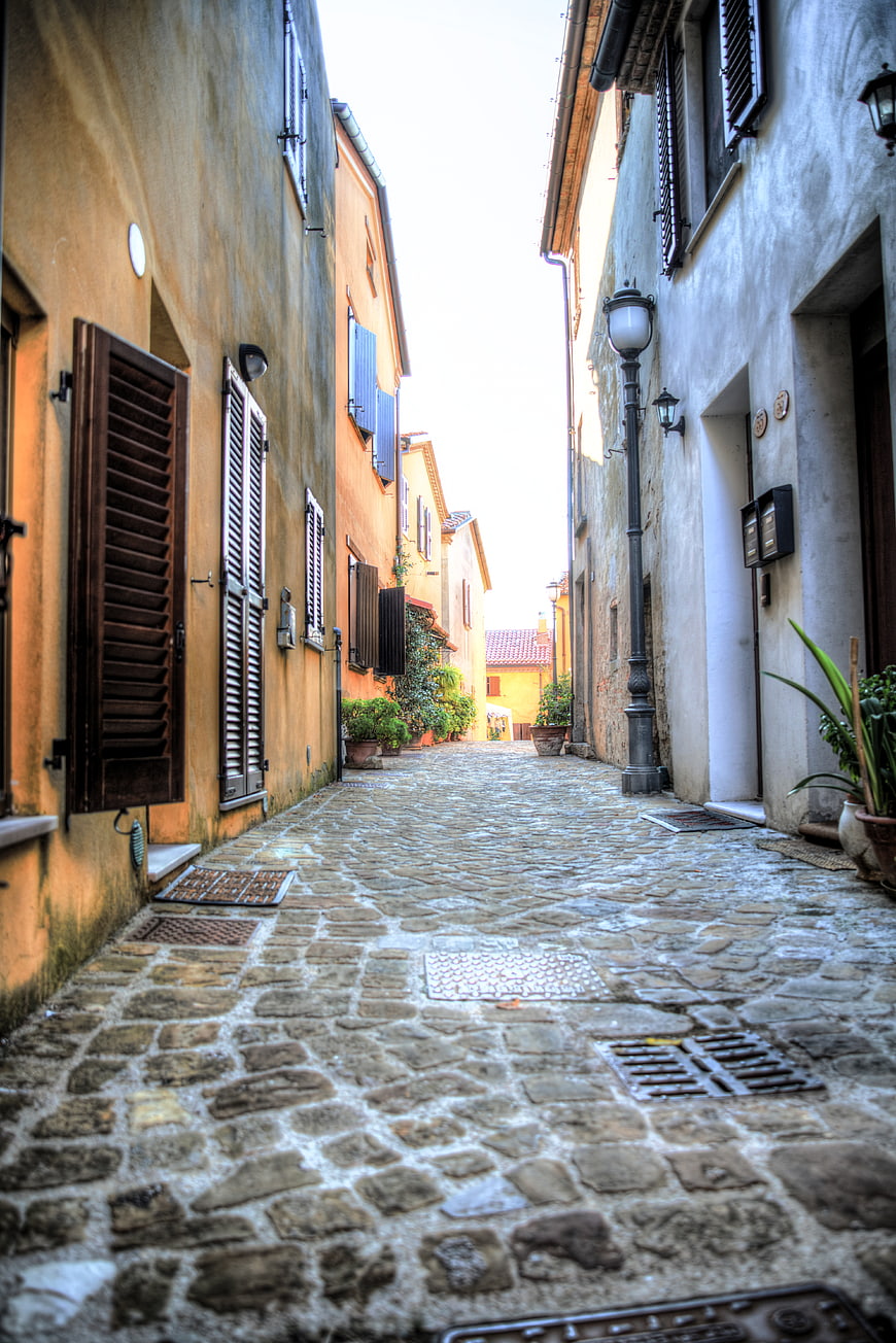 Narrow cobblestone street in Tavullia, Italy