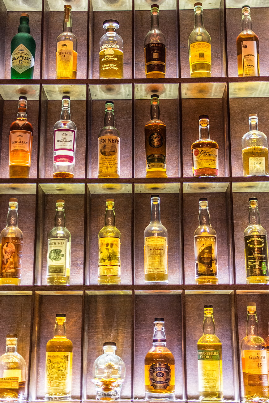 Illuminated Shelves of Premium Whiskey Bottles