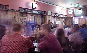 Busy Irish pub interior with blurred patrons