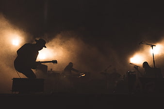Silhouetted Rock Band Performing on Smoky Stage