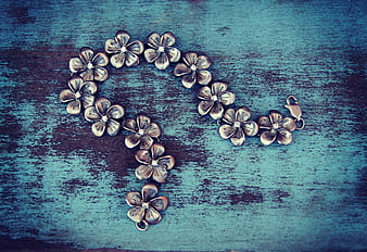 Silver Flower Bracelet On Textured Blue Wooden Surface