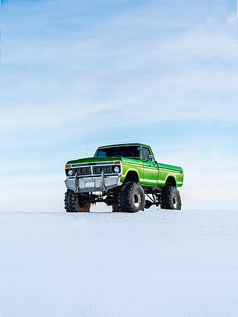 Lifted Green Vintage Ford Truck on Snowy Hill