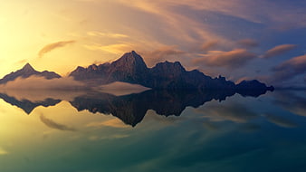 Majestic Mountain Range Reflection in Calm Lake at Sunset
