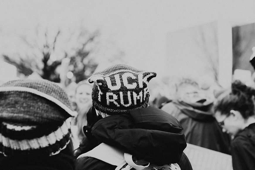 Protester wearing 'FUCK TRUMP' beanie at political rally