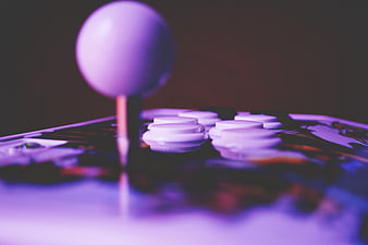 Close-up of purple arcade joystick and buttons