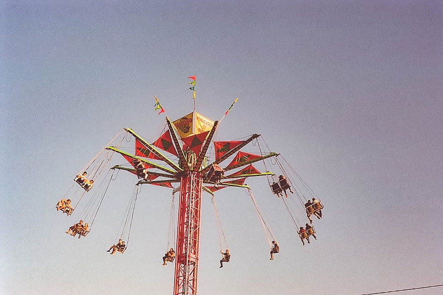 Vintage Swing Ride at Fairground Against Blue Sky
