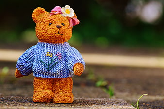 Cute Orange Teddy Bear Figurine in Blue Knitted Sweater