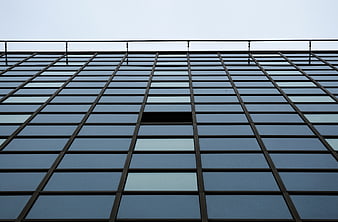 Low angle view of modern glass skyscraper facade