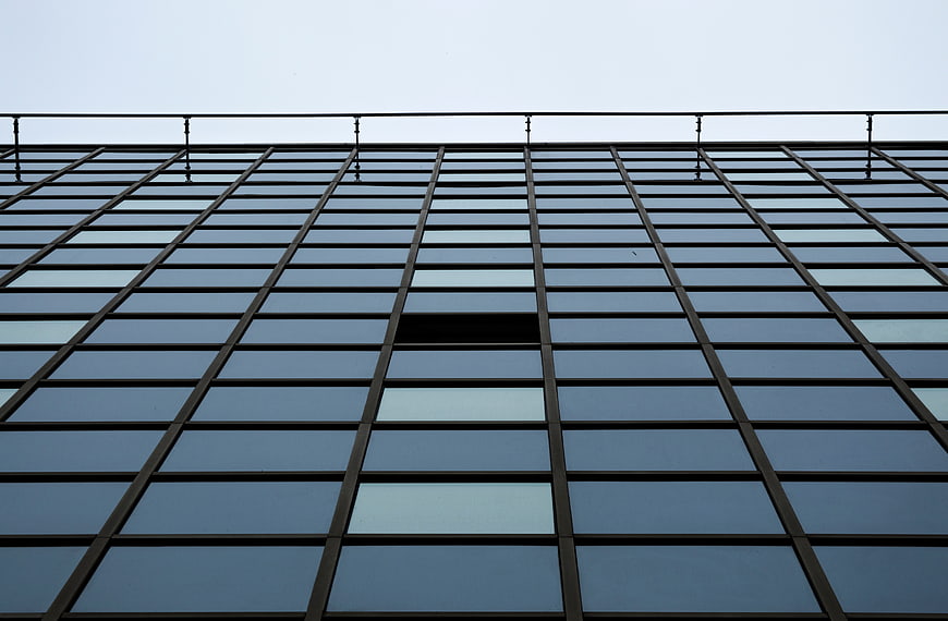 Low angle view of modern glass skyscraper facade