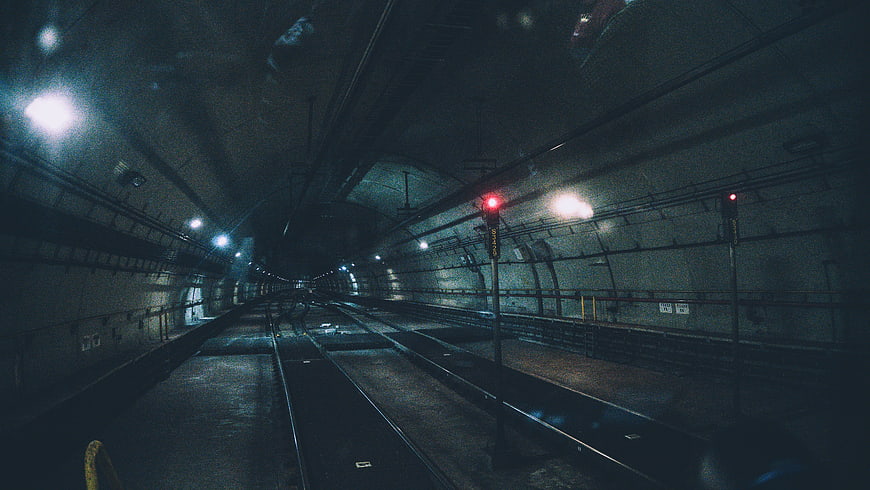 Dark Empty Subway Tunnel with Red Signal Lights
