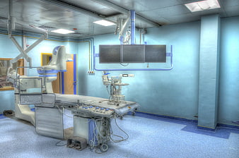 Empty Blue Catheterization Laboratory with Medical Equipment