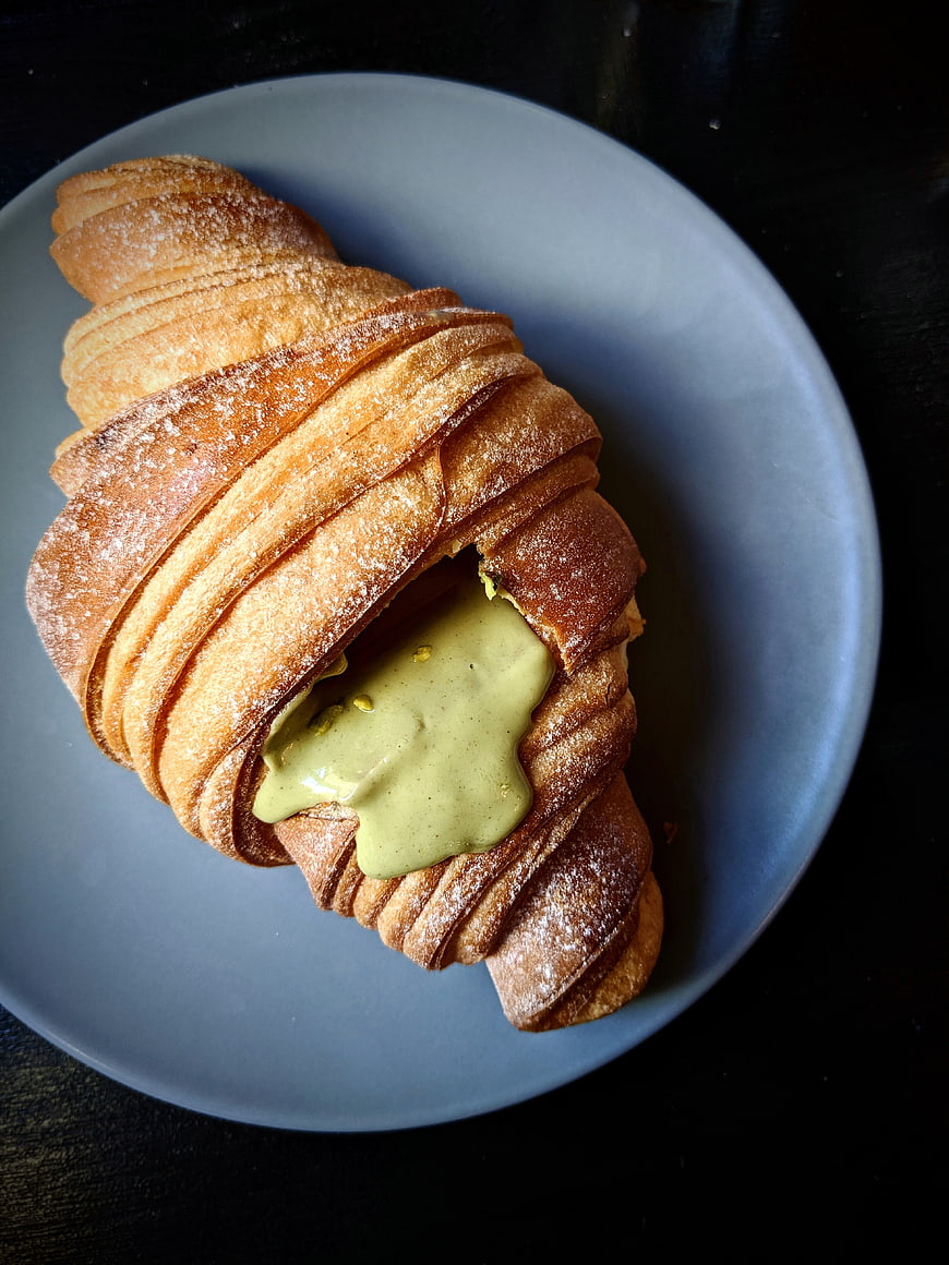 Pistachio Croissant on Blue Plate