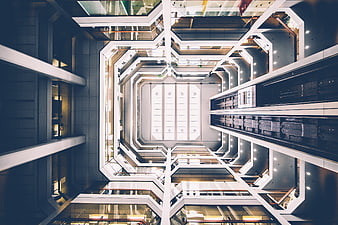 Symmetrical worm's eye view of modern office building atrium