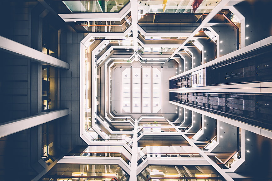 Symmetrical worm's eye view of modern office building atrium