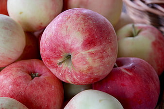 Close-up of fresh red and yellow apples in a basket