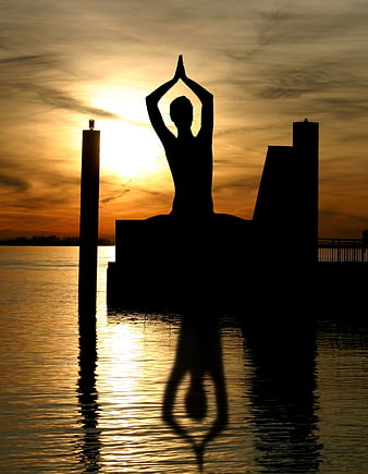 Silhouette of Buddha Statue Meditating at Sunset