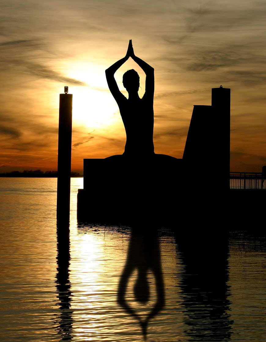 Silhouette of Buddha Statue Meditating at Sunset