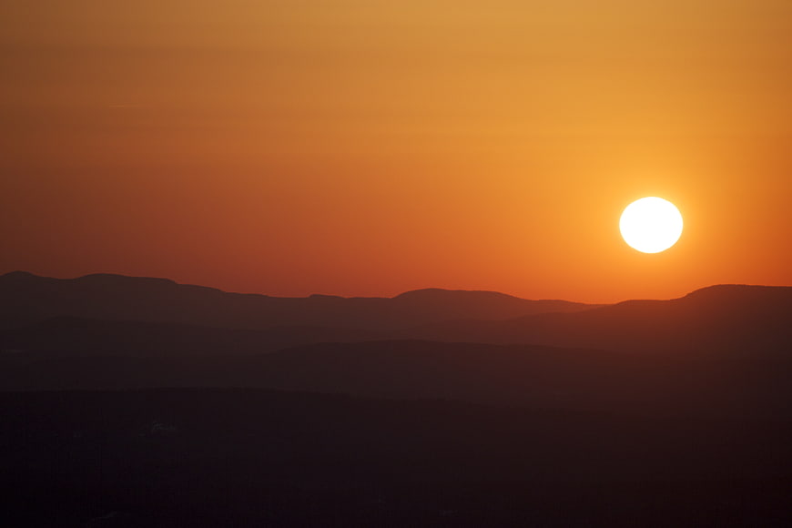 Golden Sunset Over Silhouetted Mountain Ranges