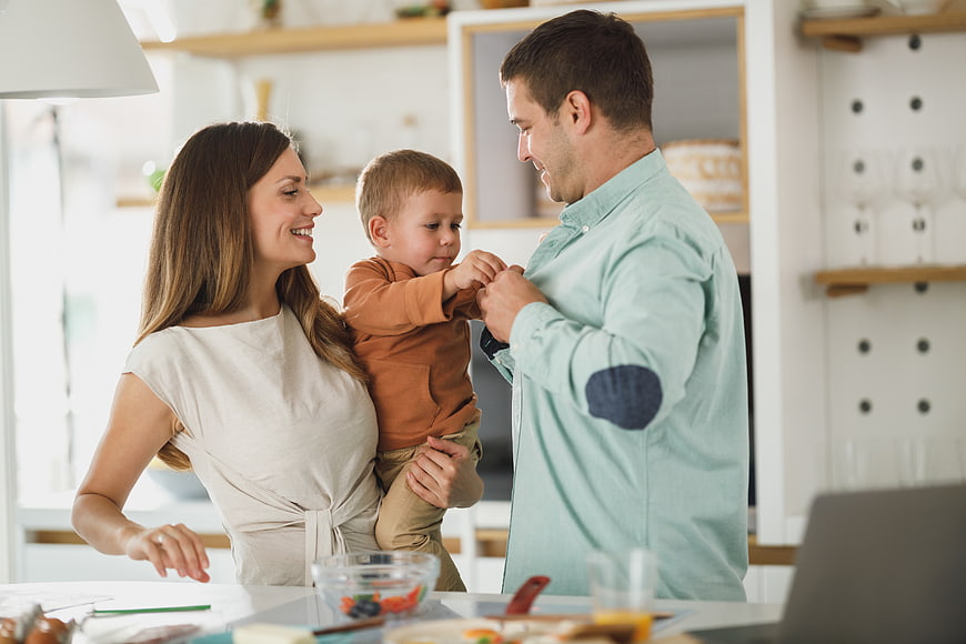 Happy family with toddler son in modern kitchen