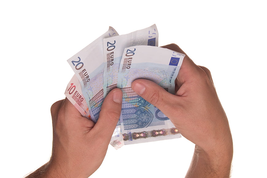 Hands holding euro banknotes on white background