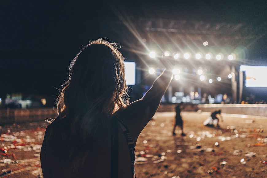 Woman at Night Music Festival with Stage Lights