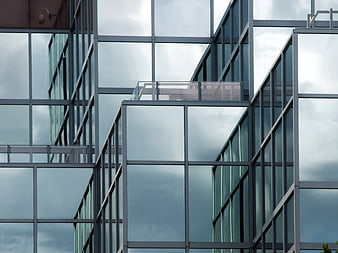 Modern Glass Office Building Facade with Sky Reflections