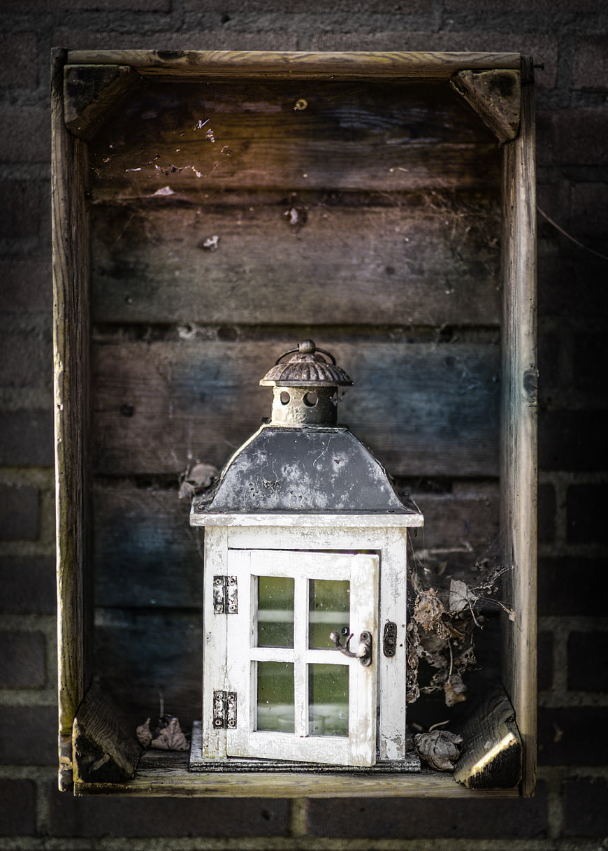 Vintage white lantern in rustic wooden box