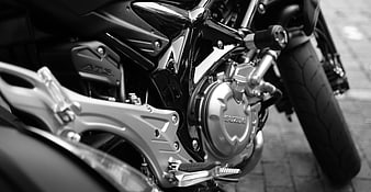 Black and white close-up of a Suzuki motorcycle engine and frame