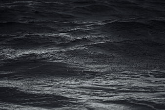 Dark moody black and white ocean waves texture