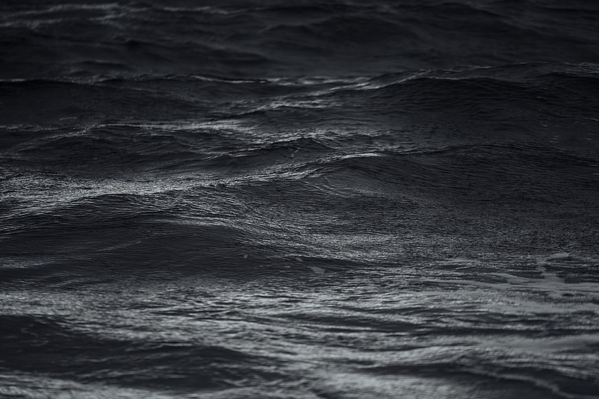 Dark moody black and white ocean waves texture