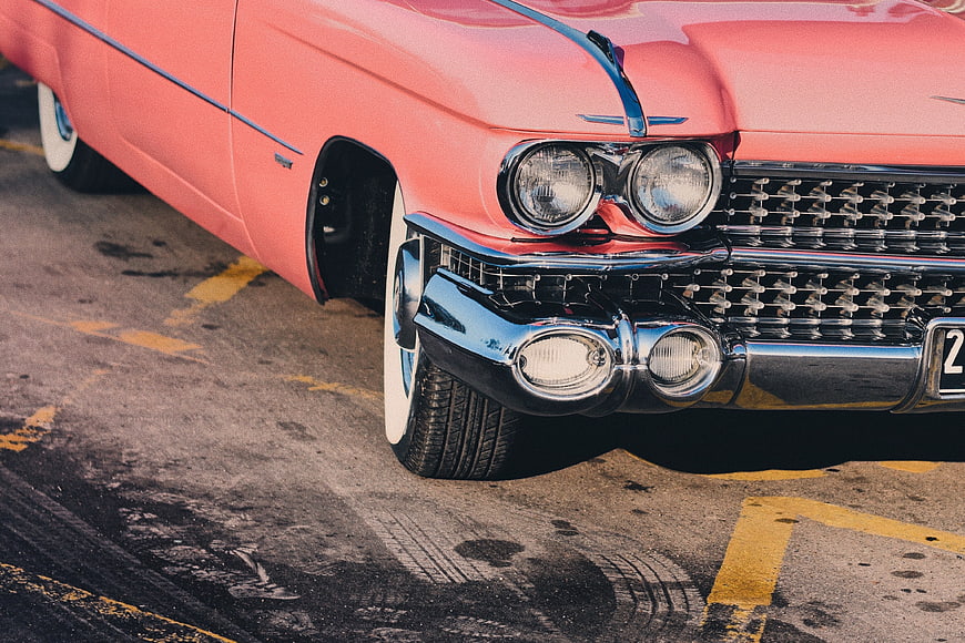 Close-up of Vintage Pink Classic Car Front Bumper