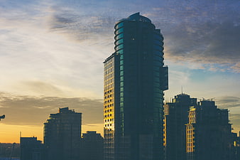 Modern Skyscrapers Silhouetted Against Golden Sunset Sky